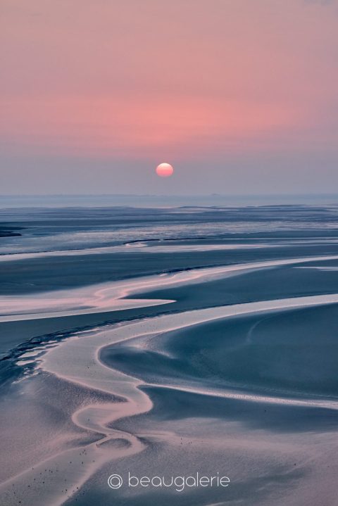 Coucher de soleil rose sur la baie du Mont Saint-Michel à marée basse
